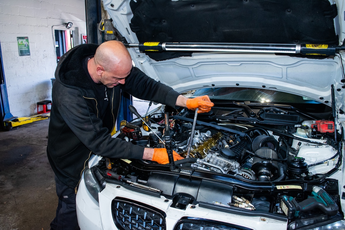 Technician repairing a car engine